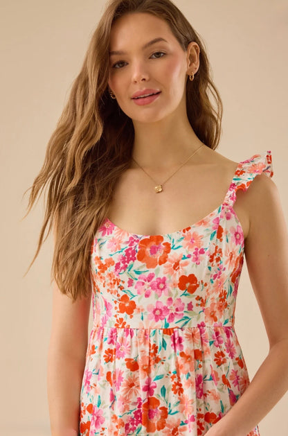 Woman wearing a floral dress against a beige background