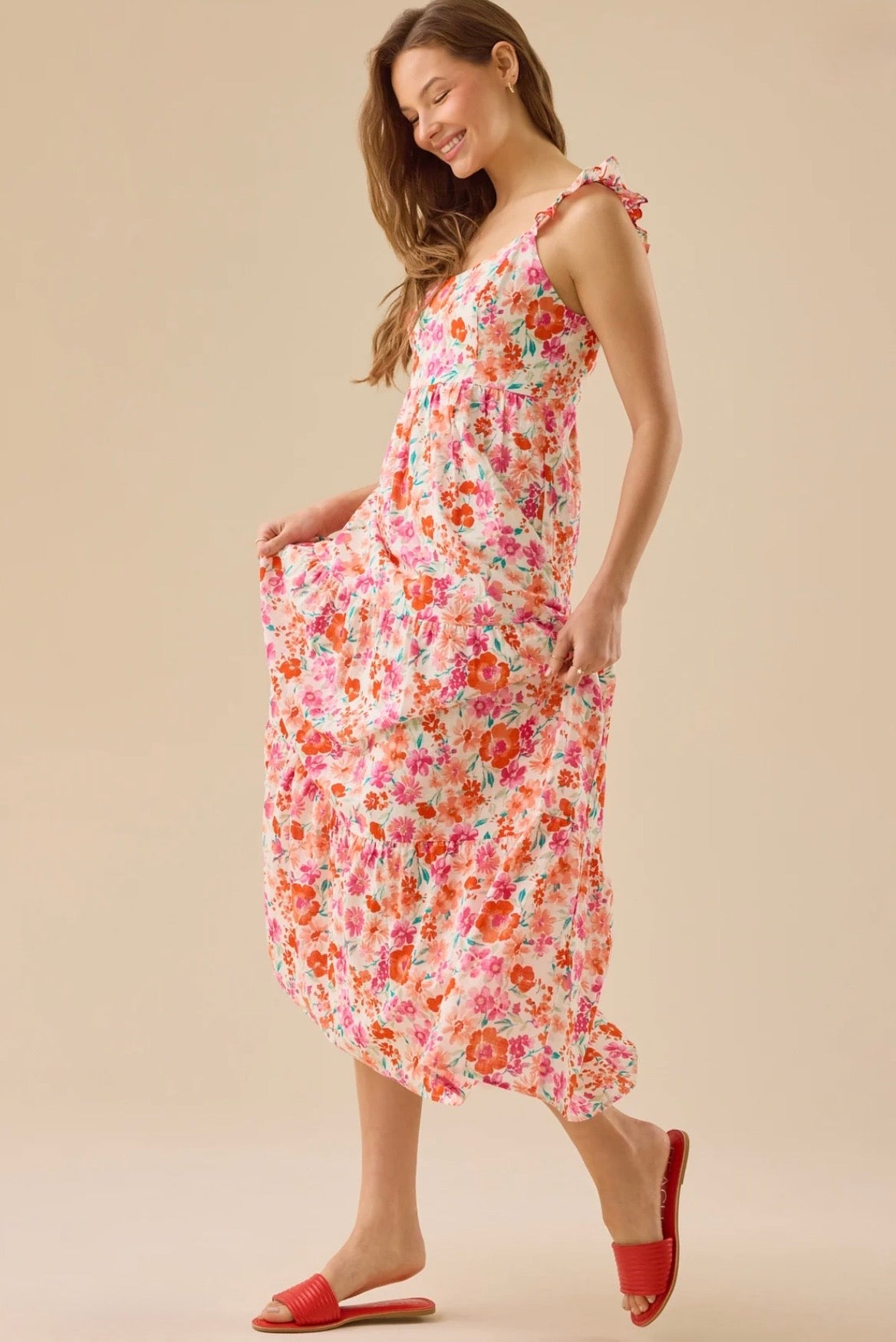 Woman wearing a floral dress on a beige background